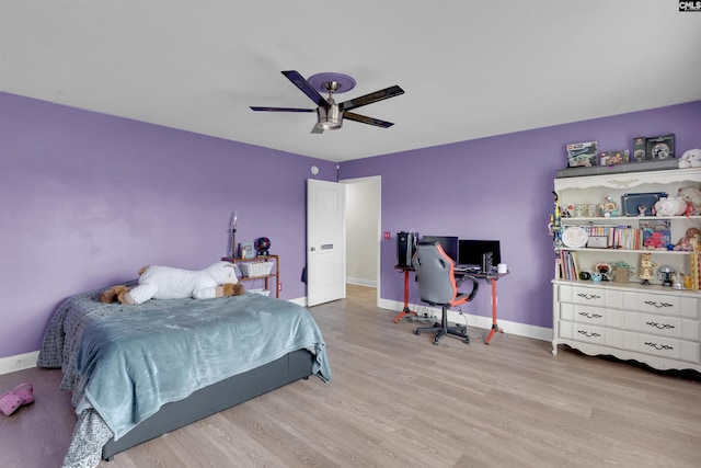 bedroom with ceiling fan and light hardwood / wood-style floors