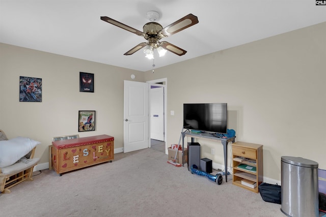 interior space with light carpet and ceiling fan