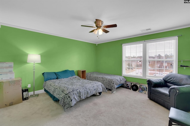 carpeted bedroom with ceiling fan and ornamental molding