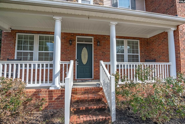 view of exterior entry with a porch