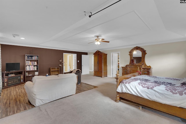 carpeted bedroom featuring ceiling fan and crown molding