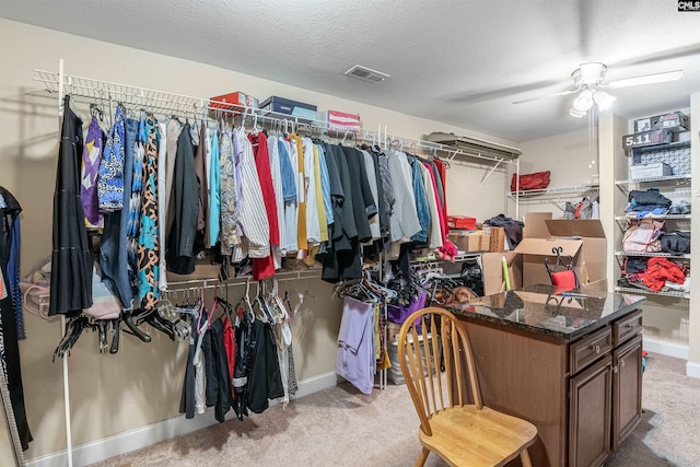 spacious closet featuring light carpet and ceiling fan