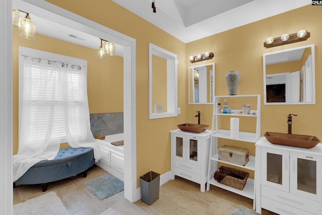 bathroom featuring tile patterned floors, a bathing tub, and vanity