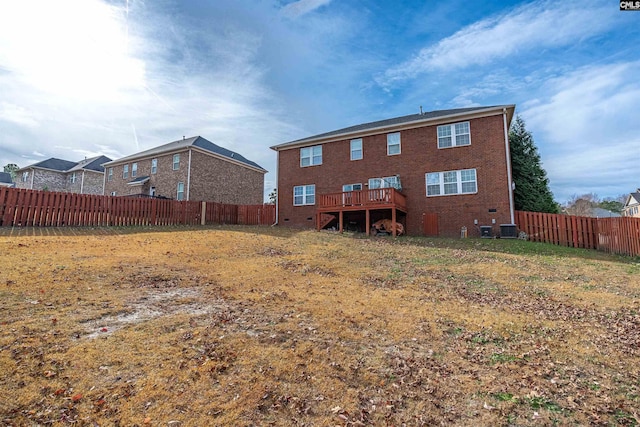 rear view of house with central AC unit and a deck