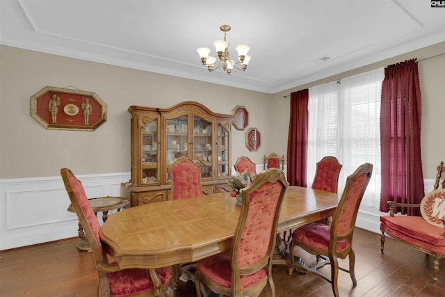 dining area featuring a chandelier, dark hardwood / wood-style floors, and ornamental molding