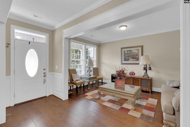 foyer entrance featuring dark hardwood / wood-style flooring and ornamental molding