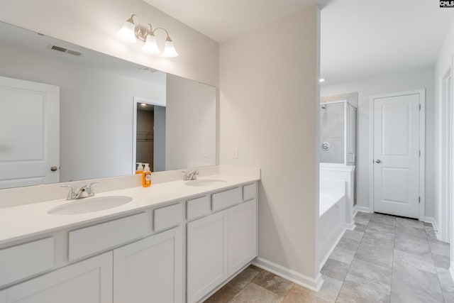 bathroom featuring tile patterned flooring, vanity, and separate shower and tub