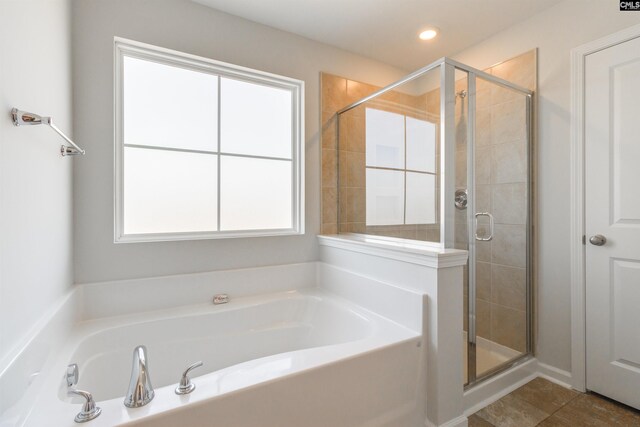 bathroom featuring tile patterned flooring and shower with separate bathtub