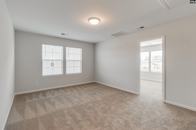 carpeted empty room with a healthy amount of sunlight