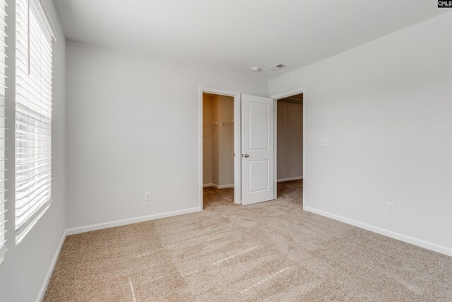 carpeted spare room featuring a wealth of natural light