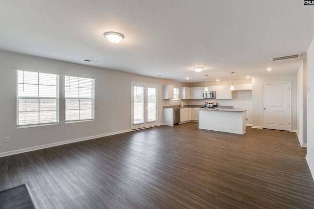 unfurnished living room featuring dark hardwood / wood-style flooring