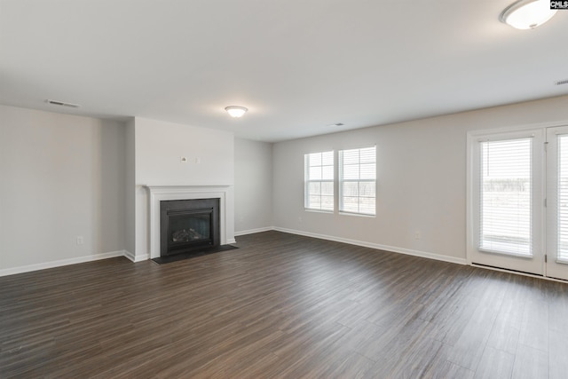 unfurnished living room featuring dark hardwood / wood-style floors