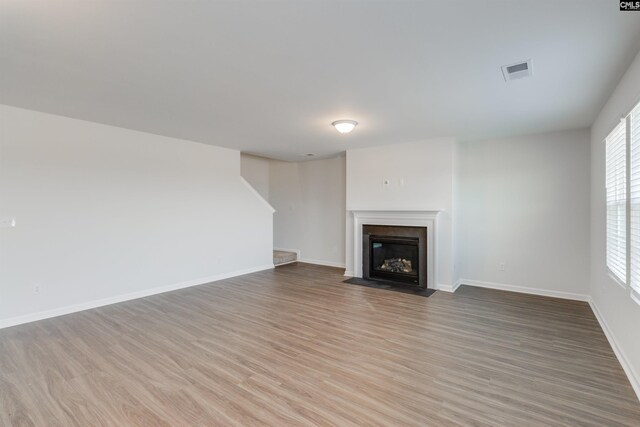 unfurnished living room featuring wood-type flooring