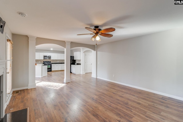 unfurnished living room with ceiling fan and wood-type flooring