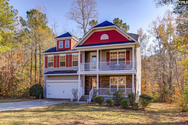 view of front of home featuring a front lawn, a porch, and a garage