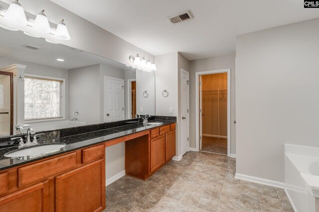 bathroom featuring a tub and vanity