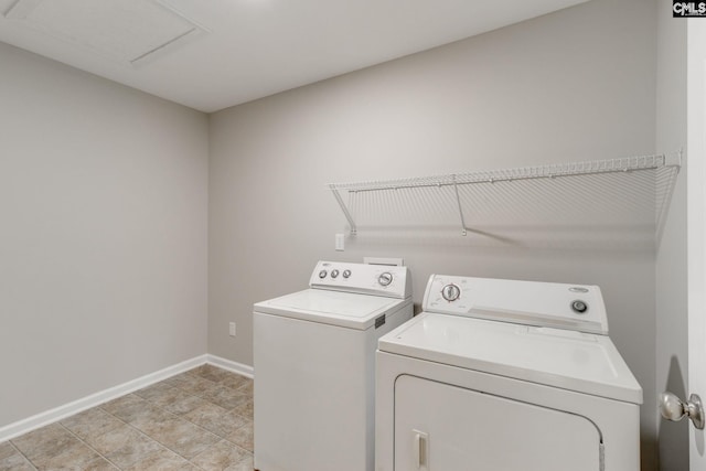 laundry room featuring light tile patterned floors and separate washer and dryer