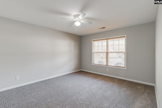 spare room featuring ceiling fan and carpet floors