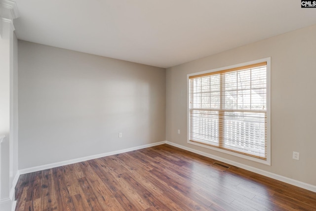 empty room with dark wood-type flooring