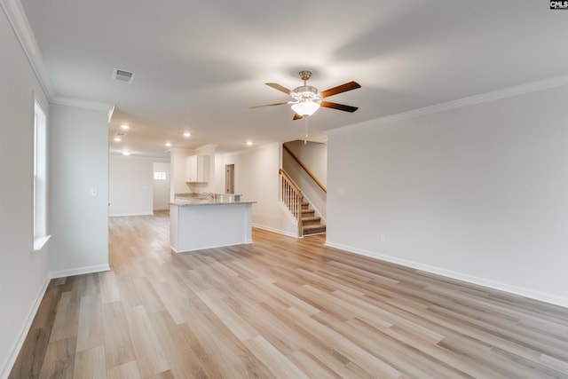 unfurnished living room featuring ceiling fan, light wood-type flooring, and crown molding