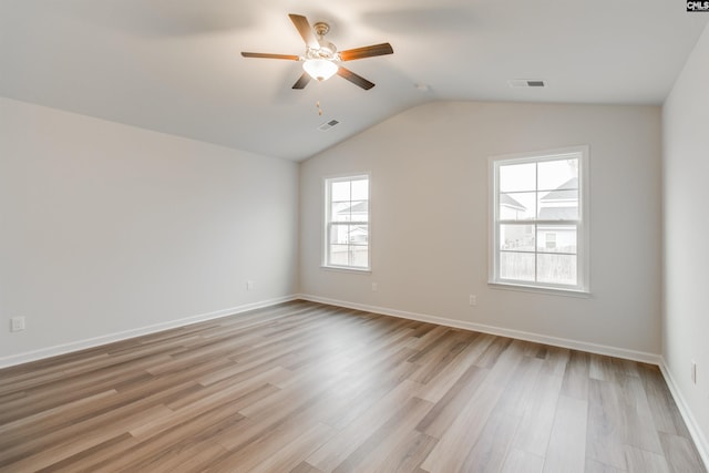 spare room with light hardwood / wood-style floors, ceiling fan, and lofted ceiling