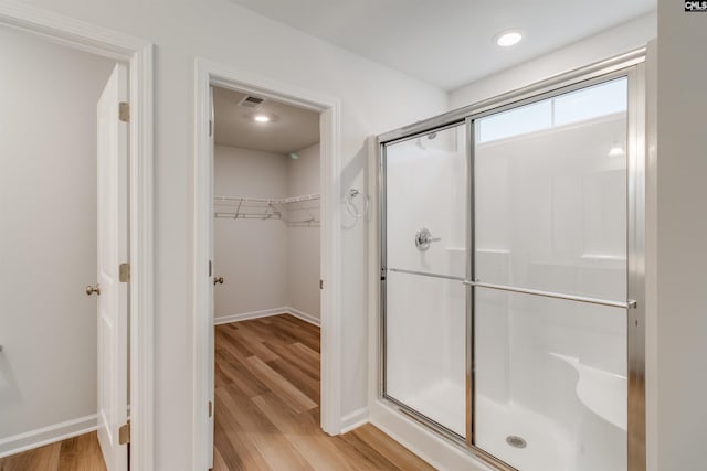 bathroom featuring walk in shower and hardwood / wood-style flooring