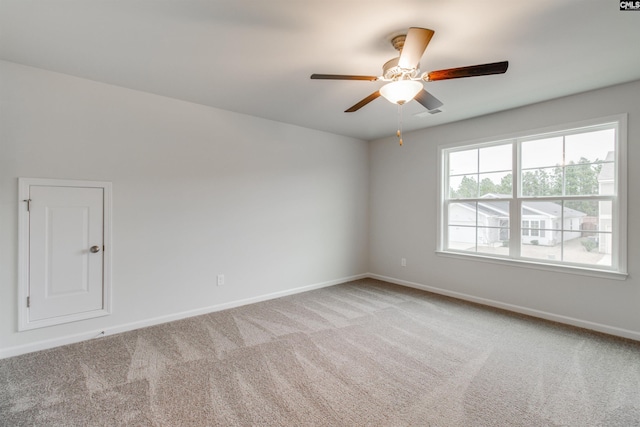 unfurnished room with ceiling fan and light carpet