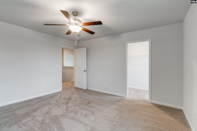 unfurnished room featuring ceiling fan and light colored carpet