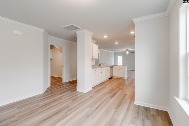 unfurnished living room with light hardwood / wood-style floors, ceiling fan, crown molding, and sink