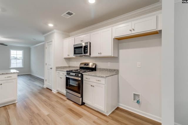 kitchen featuring light stone counters, stainless steel appliances, crown molding, white cabinets, and light hardwood / wood-style floors