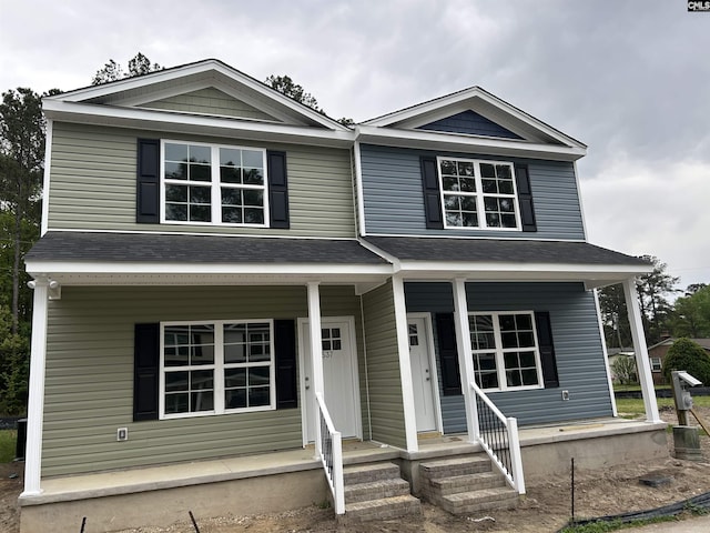 traditional-style home with a shingled roof and a porch