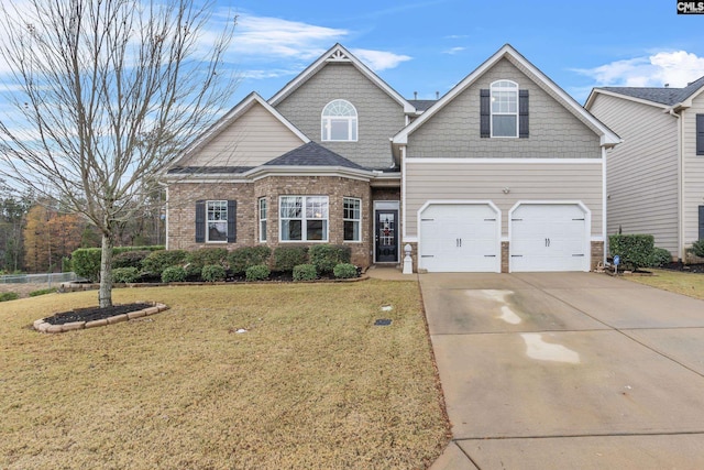 view of front of home with a front yard and a garage