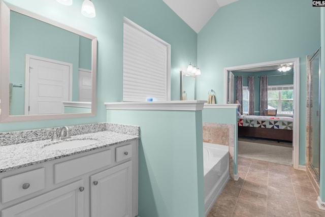 bathroom featuring vanity, vaulted ceiling, ceiling fan, plus walk in shower, and tile patterned flooring