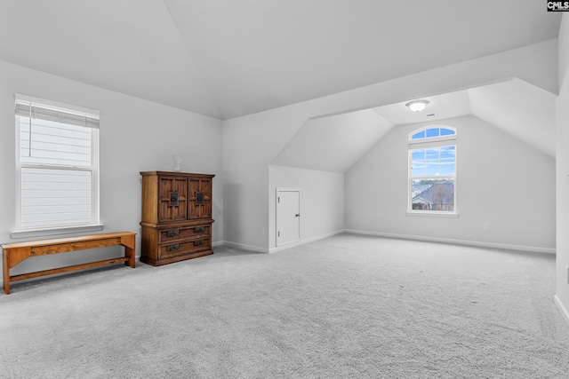 bonus room with carpet floors and lofted ceiling