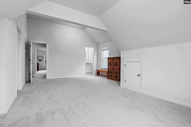 bonus room featuring light carpet and vaulted ceiling with beams