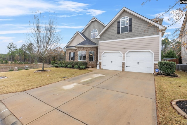 craftsman house with central AC unit and a front yard