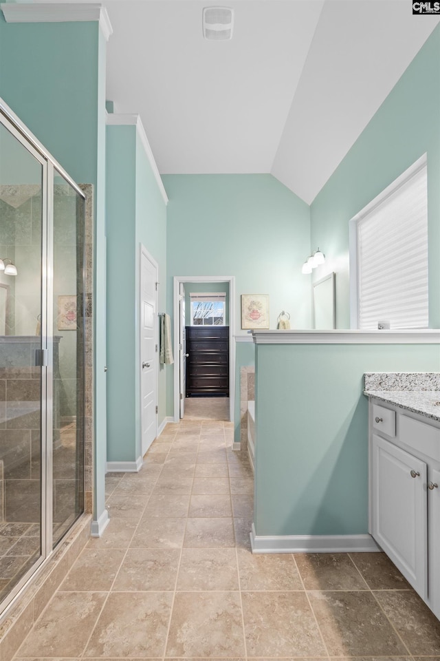 bathroom featuring tile patterned floors, vanity, separate shower and tub, and lofted ceiling