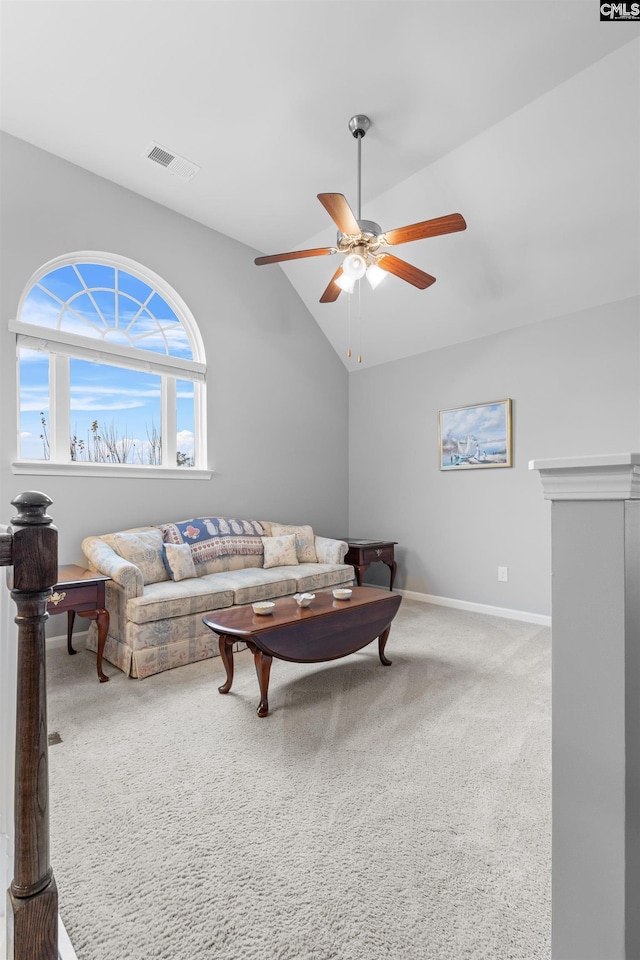 carpeted living room featuring ceiling fan and vaulted ceiling