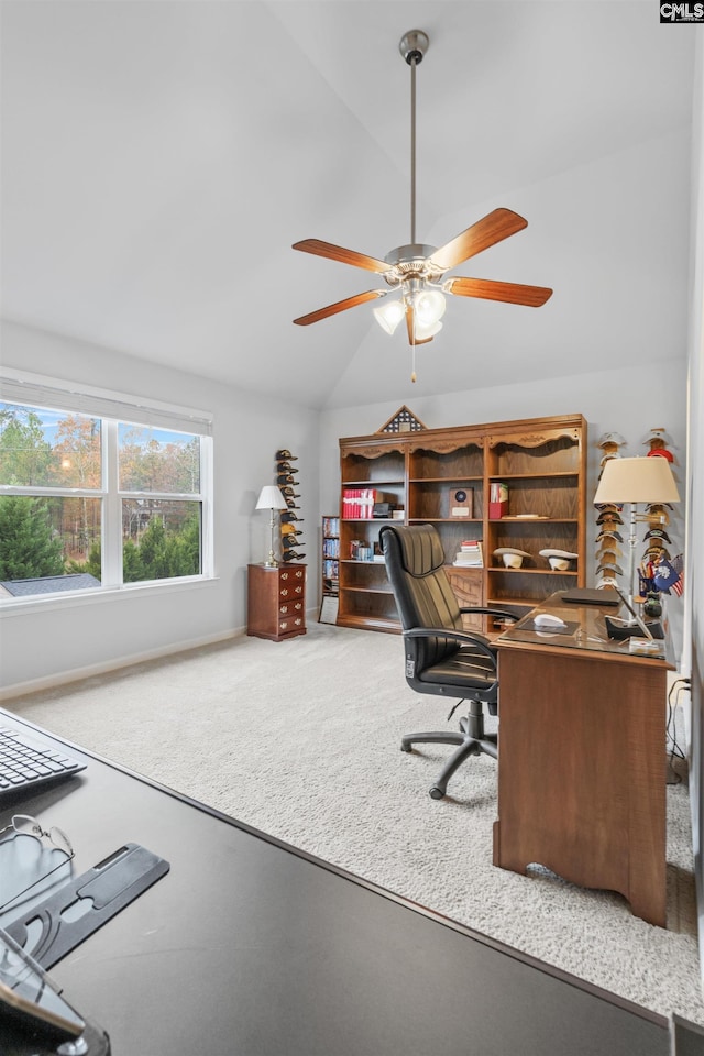 carpeted home office featuring ceiling fan and vaulted ceiling