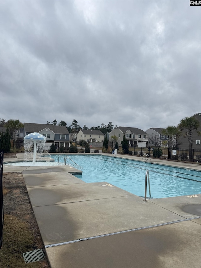 view of swimming pool with a patio area and pool water feature