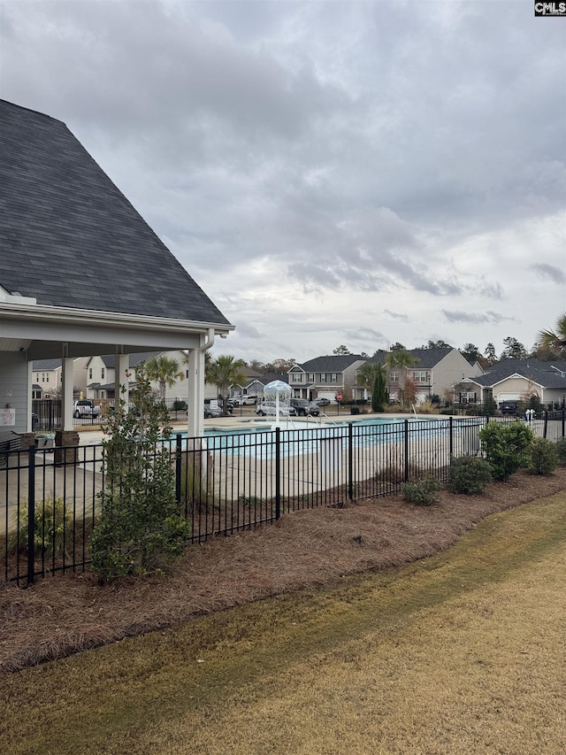 view of pool with a yard