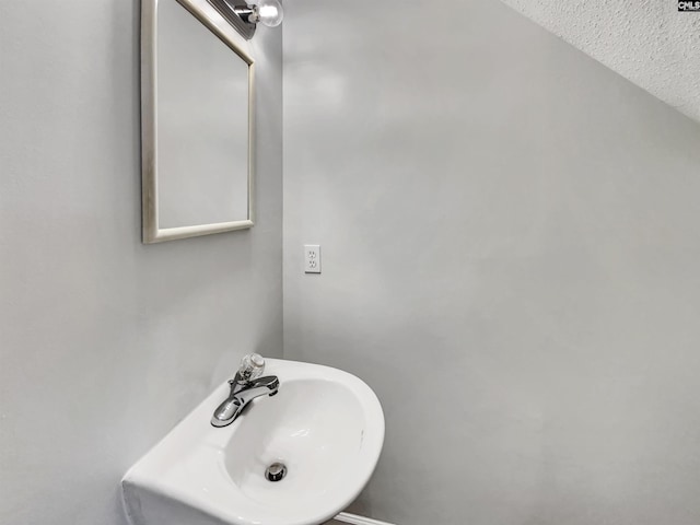 bathroom featuring sink and a textured ceiling