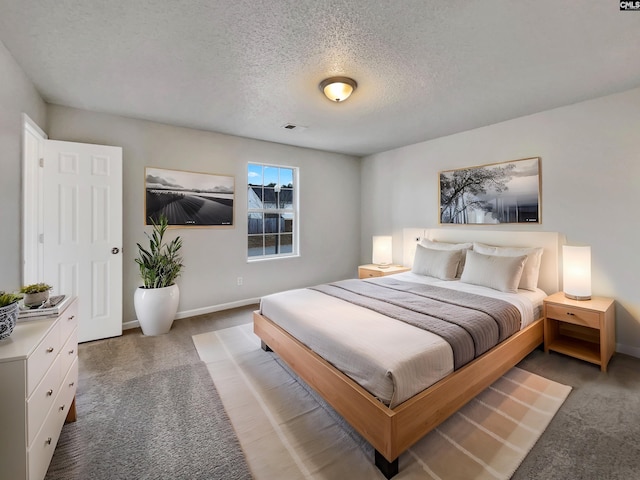 bedroom with a textured ceiling and carpet floors