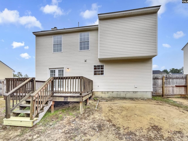 back of house with a wooden deck