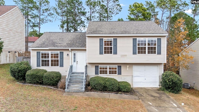 split level home with a garage and central AC