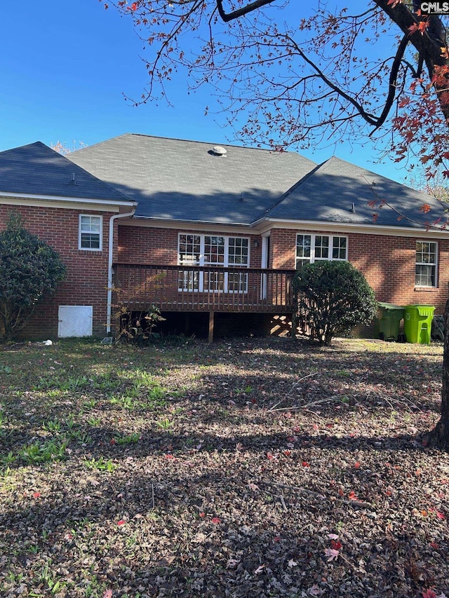 rear view of house featuring a deck