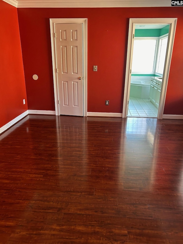 unfurnished room featuring crown molding and dark hardwood / wood-style flooring