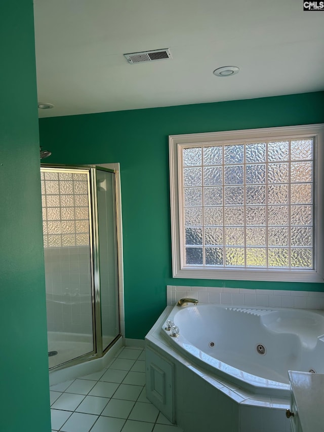 bathroom with tile patterned flooring and separate shower and tub