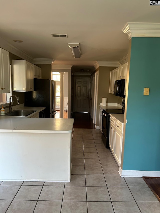 kitchen featuring light tile patterned floors, sink, ornamental molding, and black appliances