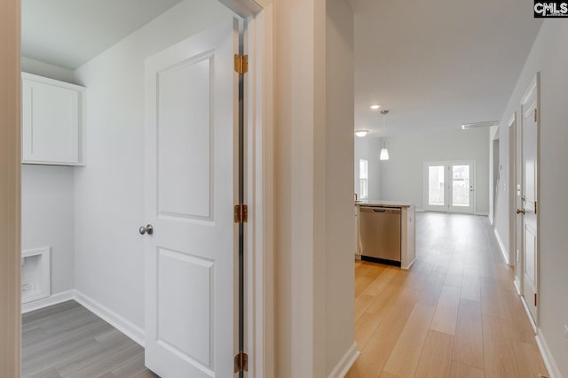 hall featuring french doors and light wood-type flooring